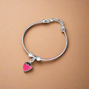 A silver bracelet with a heart-shaped charm, crafted from 925 silver, designed for children.
